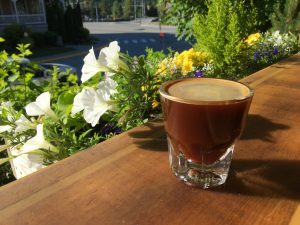 Fresh coffee at Mount Currie Coffee Co Pemberton outdoor seating with local flowers